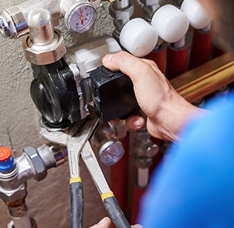 professional plumber fixing residential plumbing
